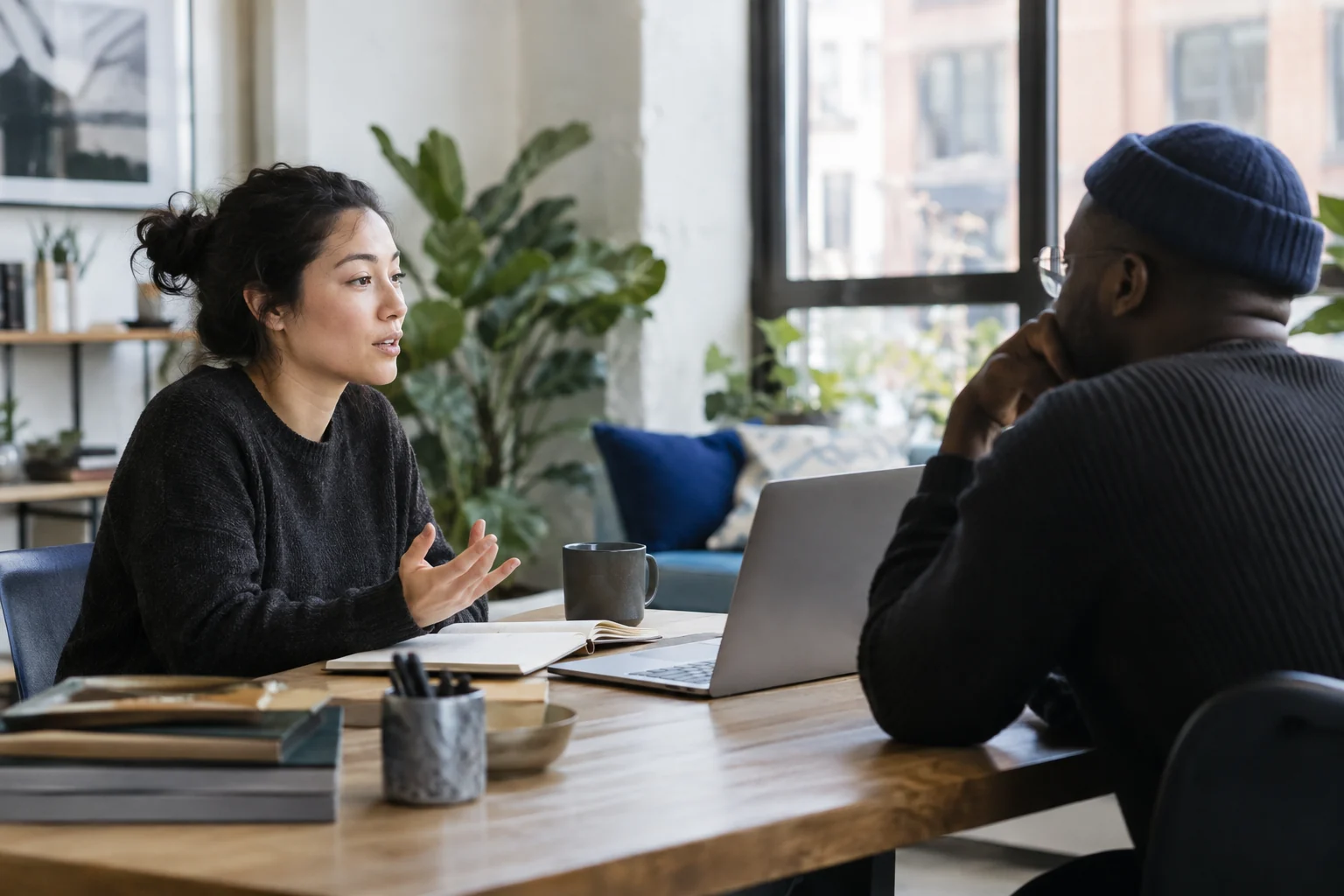Illustrative scene of two people discussing a product at a bright worktable